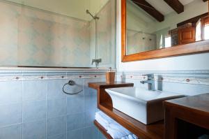 un bagno con lavandino e specchio di Casa Rural Ángela 1 a Villanueva de la Peña Altre 17 foto