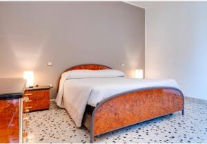 a bedroom with a large bed with a rusty frame at MeryTes - Casa vista mare in Crotone