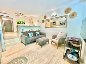 a living room with a couch and a mirror at Syrena Condo Rentals in Playa del Carmen