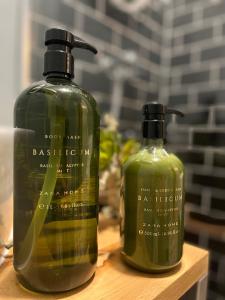 two bottles of soap sitting on a wooden shelf at W Urban Suites Budapest in Budapest