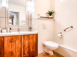 a bathroom with a sink and a toilet and a mirror at Large 2-Bedroom Apartment, Centre of Flaine Foret in Flaine +38 photos