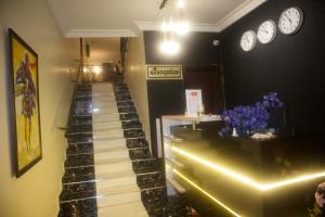 a staircase in a store with clocks on the wall at NIAS Events & Suites in Abuja