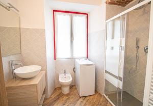 a bathroom with a toilet and a sink and a window at La primula della Valle Soana in Ronco Canavese