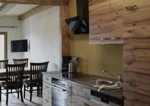 a kitchen with a sink and a table with chairs at Ferienhof Forstmoar in Gars am Inn