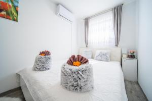a bedroom with a bed with two pillows on it at Leonardo House in Novigrad Istria