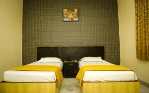 Postel nebo postele na pokoji v ubytování Hotel Arunachala