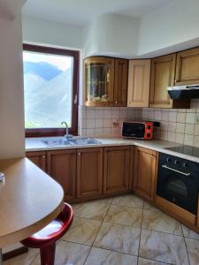 a kitchen with a sink and a window at Appartamento Gobi in Castel Condino
