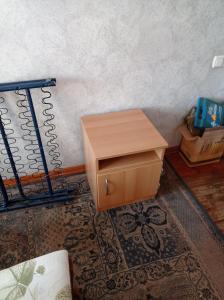 a wooden cabinet in a room with a wall at Tirgus iela 2 in Krāslava