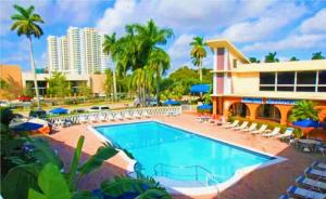 a large swimming pool in front of a building at Bposhtels Hollywood Florida in Hollywood