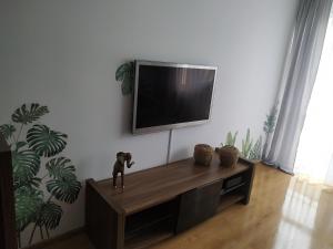 a living room with a tv on a wall at Uroczy apartament nad morzem Gdańsk in Gdańsk