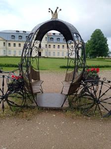 a statue of a carriage in front of a building at Tirgus iela 2 in Krāslava