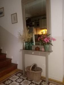 a room with a table with flowers and a mirror at clos st Joseph in Oullins