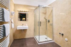 a bathroom with a shower and a sink at Apartman Residence Moser 1504 in Karlovy Vary