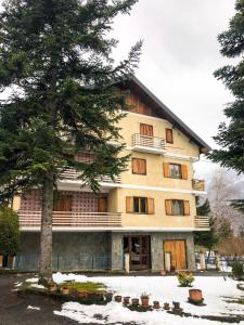 a large building with a tree in front of it at Weekend a Gravere con garage per moto (bike) e bici in Gravere