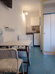 a kitchen with a table and chairs in a room at Stella di Mare in Santa Maria di Castellabate