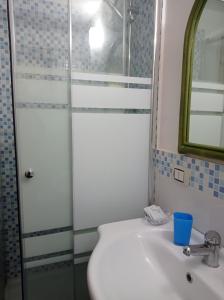a bathroom with a toilet and a sink and a mirror at Stella di Mare in Santa Maria di Castellabate
