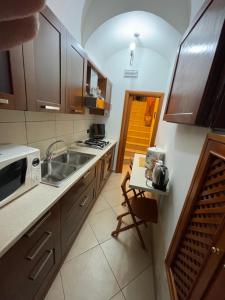 a kitchen with a sink and a stove top oven at bellini holiday home in Naples