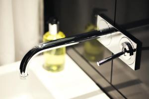 a bathroom sink with a black faucet on a counter at Boutique Barclay House London townhouse in London