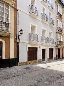 uma rua vazia em frente a um edifício branco em Apartamento Entrecatedrales em Cádiz