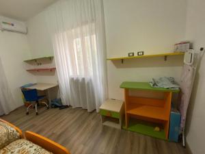 Habitación pequeña con cama, mesa y escritorio. en La casa di Gianfry, en Paola