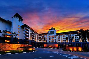 a building with a sunset in the background at Amazing View Resort Suites - Pulai Springs Resort in Skudai