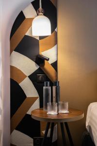 a table with two bottles on it next to a wall at Royal Saint Germain in Paris