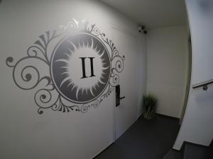 a hallway with a door with aigil on the wall at San Carlo Suite in Lugano