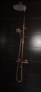 a shower in a black room with at Tabago Studio in Opole