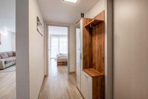 a hallway with a door to a room with a bed at MF SilverBeach 112 Apartment in Siófok