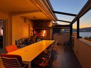 a table and chairs on a balcony with a fireplace at Apartment Rovci 1 in Slatine