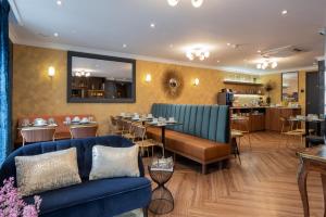 a restaurant with a blue couch and a dining room at Royal Saint Germain in Paris