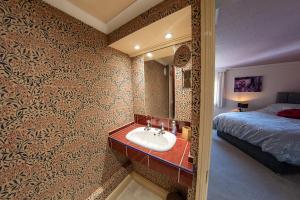 a bathroom with a sink and a bed at 3, The Dolphin, 49 Quay Street - Stunning apartment - Quintessential - Quay views - Sleeps 2-4 people in Newport