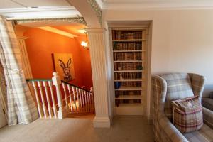 a living room with a staircase with bookshelves at 3, The Dolphin, 49 Quay Street - Stunning apartment - Quintessential - Quay views - Sleeps 2-4 people in Newport