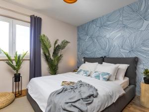 a bedroom with a bed with a blue wall at Dream Istria Holiday in Poreč