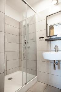 a bathroom with a shower and a sink at Fotel Mikołowska in Tychy