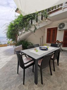 a dining table and chairs in a patio at Panorama Apartment Addaura in Palermo
