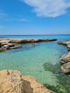 a group of people swimming in a body of water at Eva Luna in Ostuni