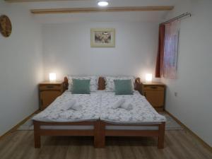 a bedroom with a large bed with blue pillows at Pegaz in Slappe dʼIdria