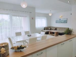 a kitchen and living room with a table and chairs at Apartments Nina in Maslenica