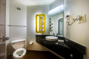 a bathroom with a sink and a toilet and a mirror at Motel 6-Burlington, ON - Toronto West - Oakville in Burlington