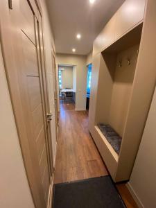 a hallway with a door and a room with a table at BLUE SKY APARTMENT in Jūrmala