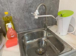 a kitchen sink with a faucet and a cup at Newly Renovated (Trial Price Now) Bukit Mertajam in Bukit Mertajam