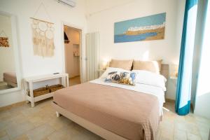 a bedroom with a bed and a bathroom at Donnamaria - Dimora Vista Mare in Polignano a Mare