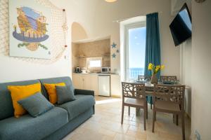 a living room with a couch and a dining room table at Donnamaria - Dimora Vista Mare in Polignano a Mare