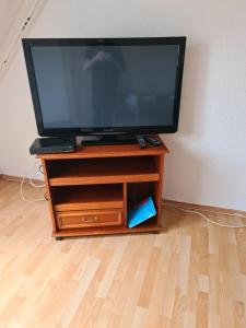 a flat screen tv sitting on a wooden stand at TS1 2-OG Möbilierte Wohnung in Wolfsburgs Zentrum in Wolfsburg