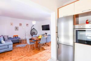 a kitchen and living room with a stainless steel refrigerator at Apartments Sandra in Orebić