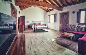 a living room with two beds and a couch at Casa en La Ladera - Real vibe - Beach & Mountain in La Aldea de San Nicolas