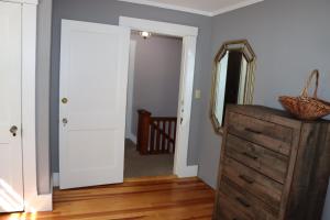 a room with a dresser and a mirror on a door at Sea View Motel in Ogunquit