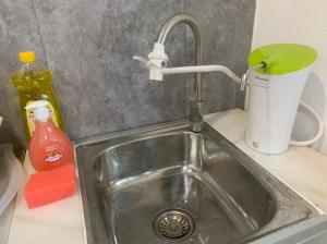 a kitchen sink with a faucet and a cup at Kota Permai Mini Rest Room 99 Full Equipped in Bukit Mertajam