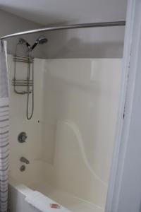 a shower in a bathroom with a tub at Sea View Motel in Ogunquit